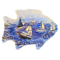 Decorative plate with sailboat design on a white background